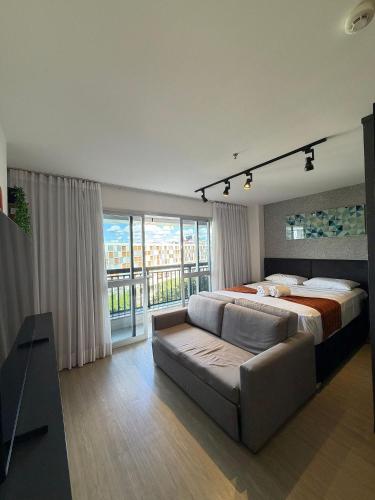 a large bedroom with a bed and a couch at Hotel VISION in Brasília