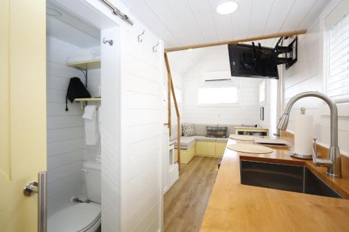 a kitchen with a sink and a toilet in a room at River and Twine in Rocky Mount