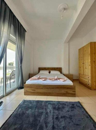 a bedroom with a bed and a large window at Tropical apartment in Flogita