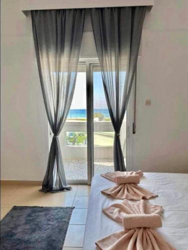 a bedroom with a bed with a large window at Tropical apartment in Flogita