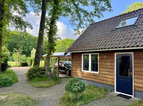 a house with a car parked in front of it at De Boase in Voorthuizen