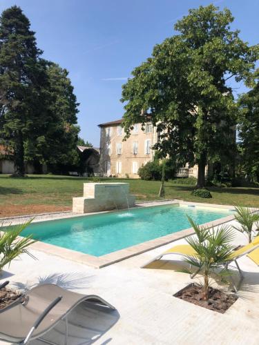 a swimming pool in front of a large building at Chateau de Vaugelas - Charmant domaine près de Valence in Alixan