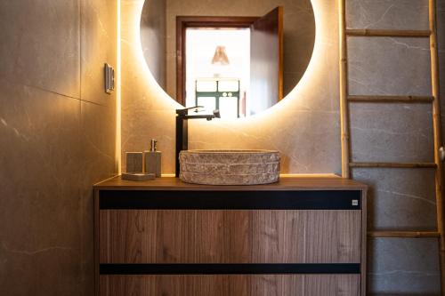 a bathroom with a sink and a mirror at Ponta do Sol hills view 2BR in Ponta do Sol