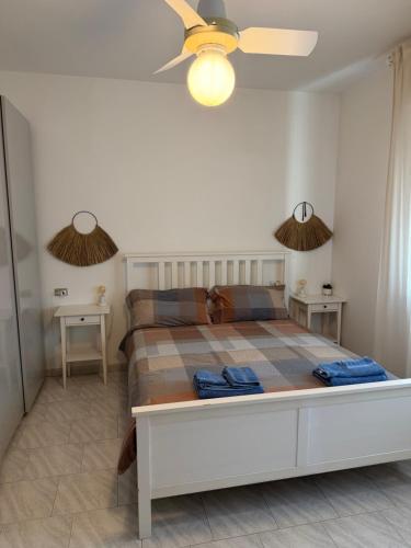 a bedroom with a large bed with two tables at Perla del Mare in Cesenatico