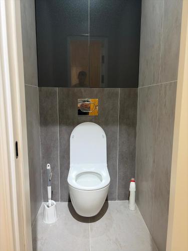 a bathroom with a white toilet in a stall at Jamshed apartment in Samarkand