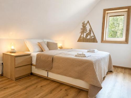 a bedroom with a bed and a window at Chalupa pod Špičákem in Smržovka