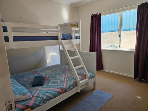 a bedroom with a bunk bed with a ladder at Hopetoun - footprints in the sand in Hopetoun