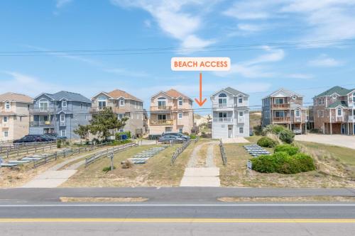 a house with a sign that reads beach access at Fun 'N Sun - Nags Head MP 16, 250 Ft to Beach Access, Pool, Pets OK, YR Flex Stays in Nags Head
