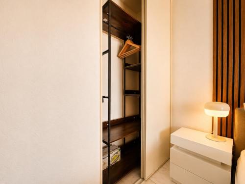 a walk in closet with a glass door at La Terrasse Bleue-Parking couvert-2 min plage-Juan Les Pins in Antibes