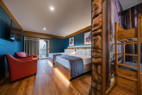 a bedroom with two bunk beds and a chair at Great Wolf Lodge Waterpark Resort in Niagara Falls