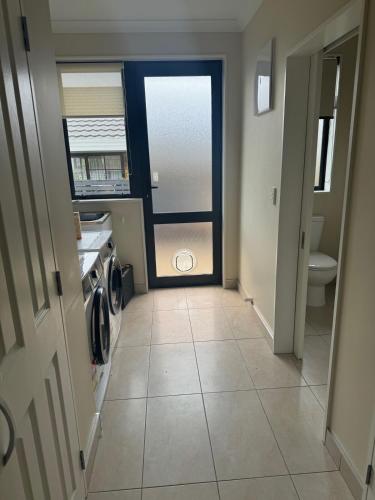 a hallway with a door leading to a bathroom at Duke St Townhouse in Cambridge