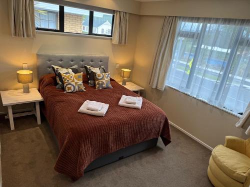 a bedroom with a large bed with two towels on it at Duke St Townhouse in Cambridge