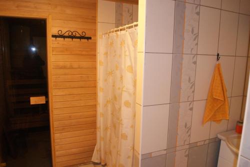 a bathroom with a shower with a shower curtain at Sepa Talu in Aakre