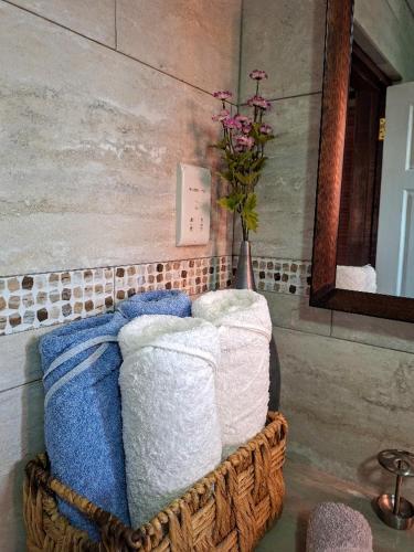 a bunch of towels in a basket in a bathroom at Eden Crest Villa in Anse La Raye