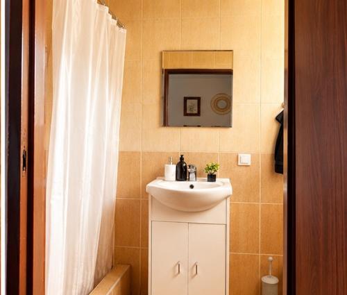 a bathroom with a sink and a mirror at Big Foot by MANGO Food&Bar in Karwia