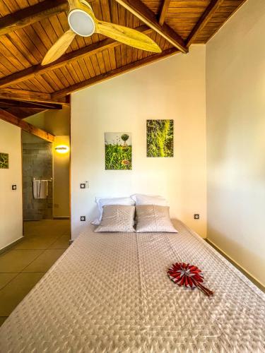 a large bed in a bedroom with a wooden ceiling at Bohème Chic, 2 Suites, Terrasse XXL in Le Gosier