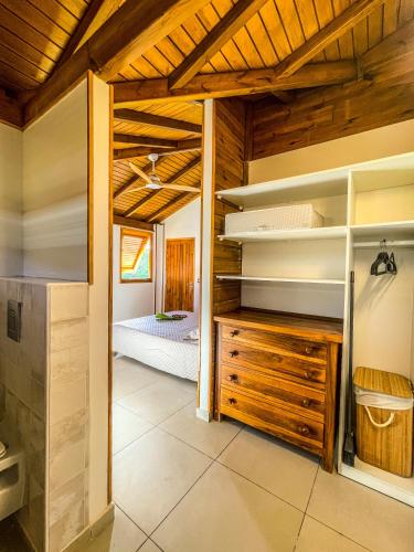 a room with wooden ceilings and a bedroom at Bohème Chic, 2 Suites, Terrasse XXL in Le Gosier