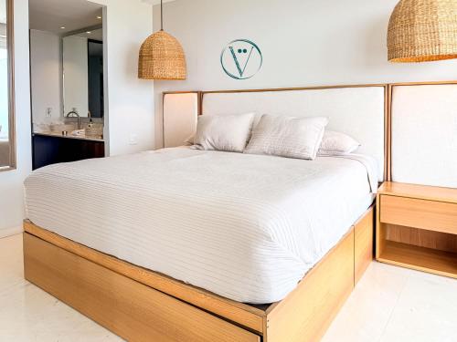 a bedroom with a large bed with a mirror at Endless Ocean Views Luxury Bolongo Escape in Higuera Blanca