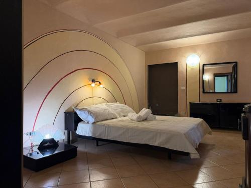 a bedroom with a large bed with an arch above it at Il Rustico di Calosso in Calosso