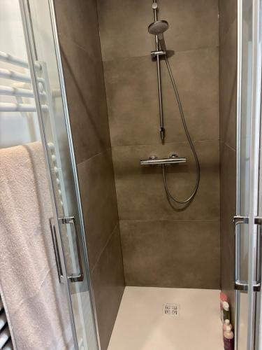 a bathroom with a shower with a glass door at La Dune Dorée Escapade Croteloise in Le Crotoy