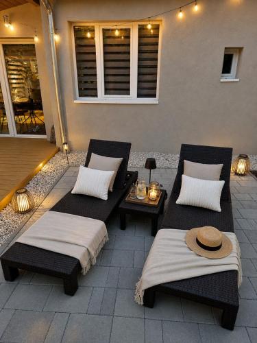 two beds sitting on a patio with a table at Balatoni Horizont Vendégház in Balatonakarattya