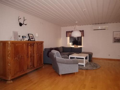 a living room with a couch and a table at Cozy cabin near the river in Kangos