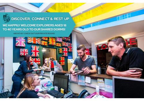 a group of people standing at a counter in a store at Rest Up London in London