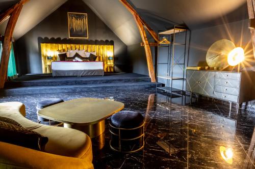 a bedroom with a bed and a table and chairs at Domaine Malar in Guillerval