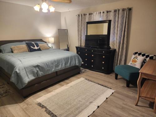 a bedroom with a bed and a dresser with a mirror at H20 paradise in Texas City