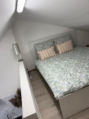 a bed in a small room with a white bed frame at Studio in Geraardsbergen