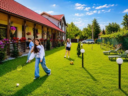 a group of people playing a game of badminton at Serenity Garden Villa in Runcu