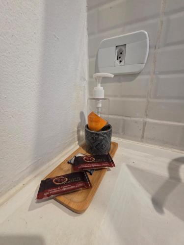 a bathroom sink with a soap dispenser and an orange at Villa Dona Jaca - Cabana 01 in Socorro