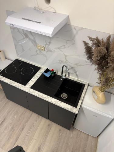 a kitchen counter with a sink and a counter top at Studio in Geraardsbergen