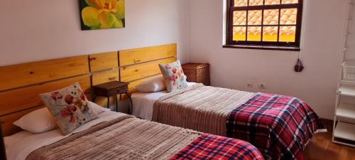 a bedroom with two beds and a window at Mgrahamhouse in Tacoronte