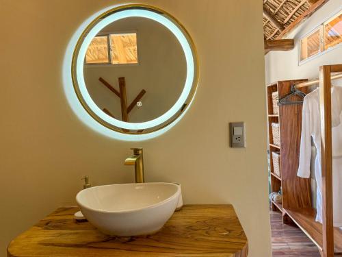 a bathroom with a large mirror and a tub on a table at Seúl Haus in El Sunzal