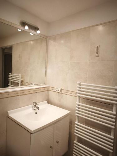a bathroom with a sink and a mirror at Appartamento Sole in Nice