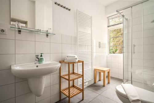 a white bathroom with a sink and a shower at Hotel Bolter Mühle - DZ Gerstenkammer in Rechlin