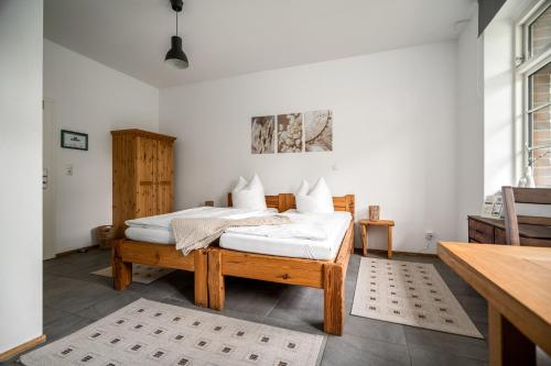 a bedroom with two beds and a table at Roggenkammer in Rechlin