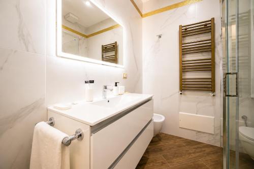 a bathroom with a sink and a toilet and a shower at Villa In Bed in Naples