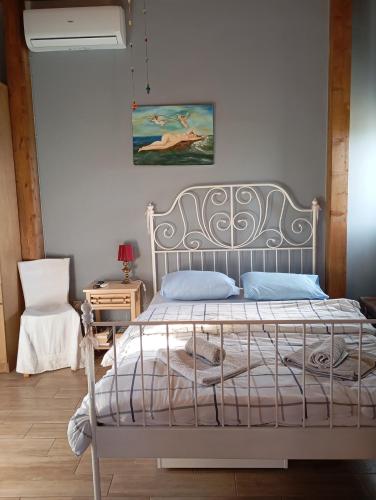 a bedroom with a bed with a white bed frame at gialos house in Livadia