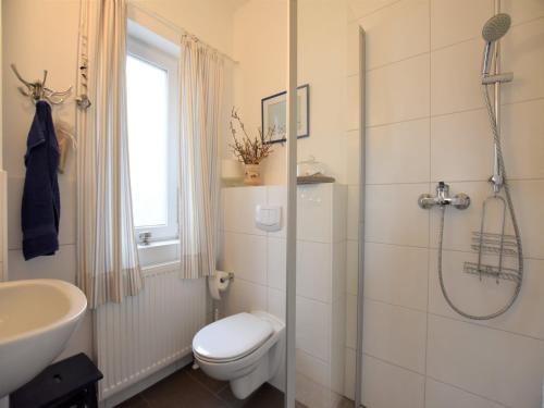 a bathroom with a shower and a toilet and a sink at Ferienhaus in Zierow am Strand in Zierow