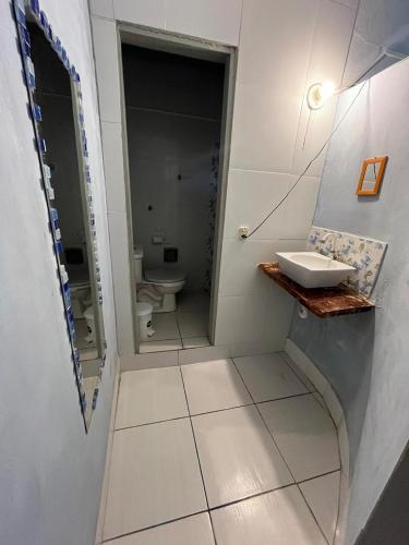a bathroom with a sink and a toilet at Blue Day in Canoa Quebrada