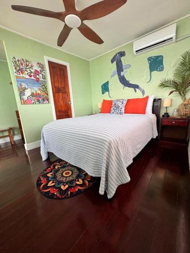 a bedroom with a bed and a ceiling fan at The Jungle Hotel and Bar in Bocas Town