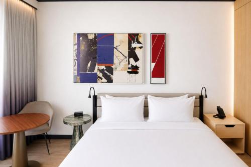 a hotel room with a bed and a table at The William Vale in Brooklyn