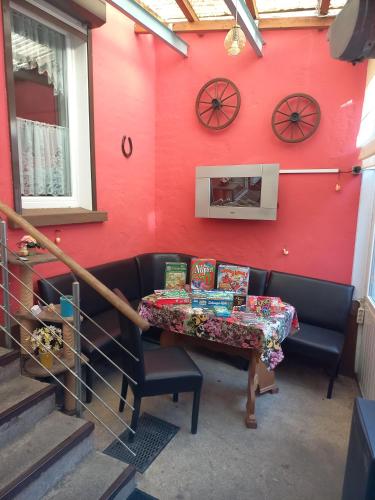 a table in a room with a red wall at Ferienwohnung Familie Rudolf in Coswig
