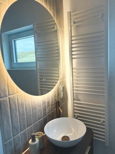 a bathroom with a white sink and a mirror at Ostoja Janowice in Janowice