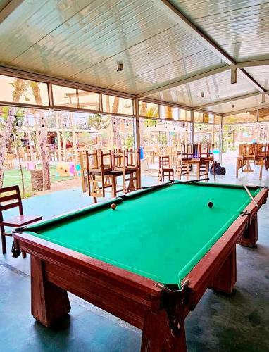 a pool table in a pavilion with tables and chairs at Hacienda Hotel Colpa in Chincha