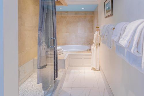 a bathroom with a shower and a bath tub at Breakwater Inn in Kennebunkport