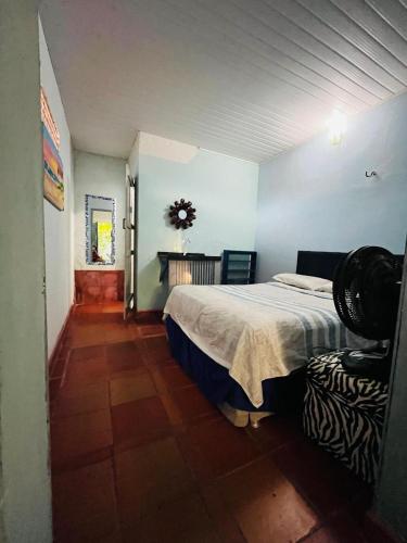 a bedroom with a bed and a table in it at Blue Day in Canoa Quebrada