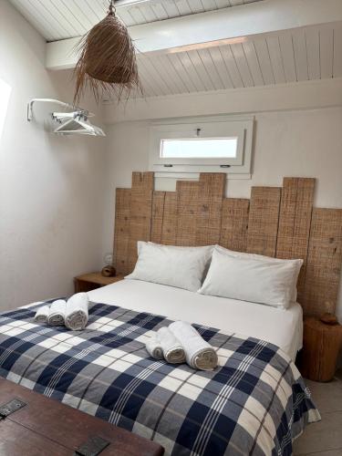 a bedroom with a bed with towels on it at The three bell towers apartment in Alghero